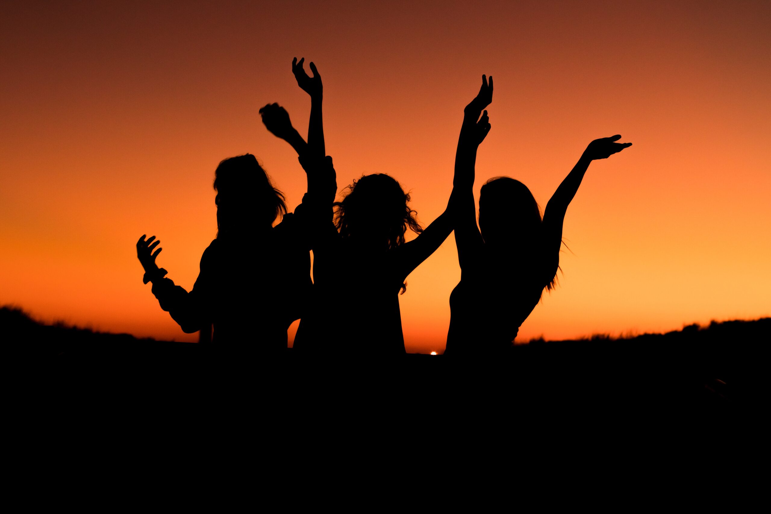 women celebrating sunset
