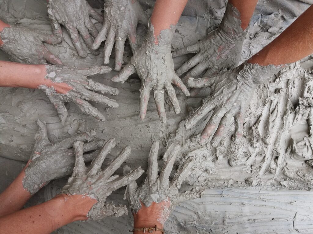 BENTONITE CLAY 1 hands covered in clay